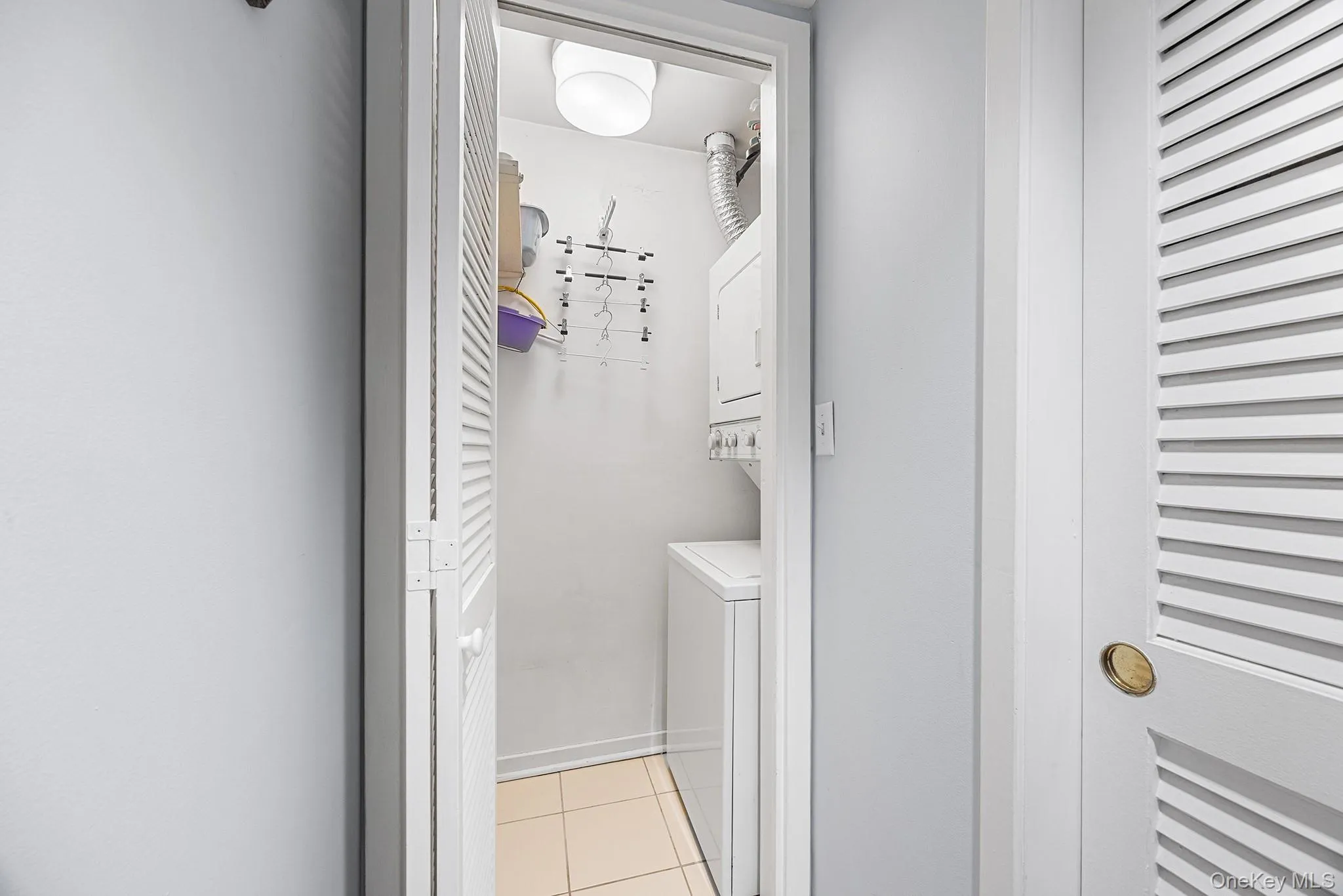 Entry hall with closet to right and separate laundry closet. Entry hall with closet to right and separate laundry closet.