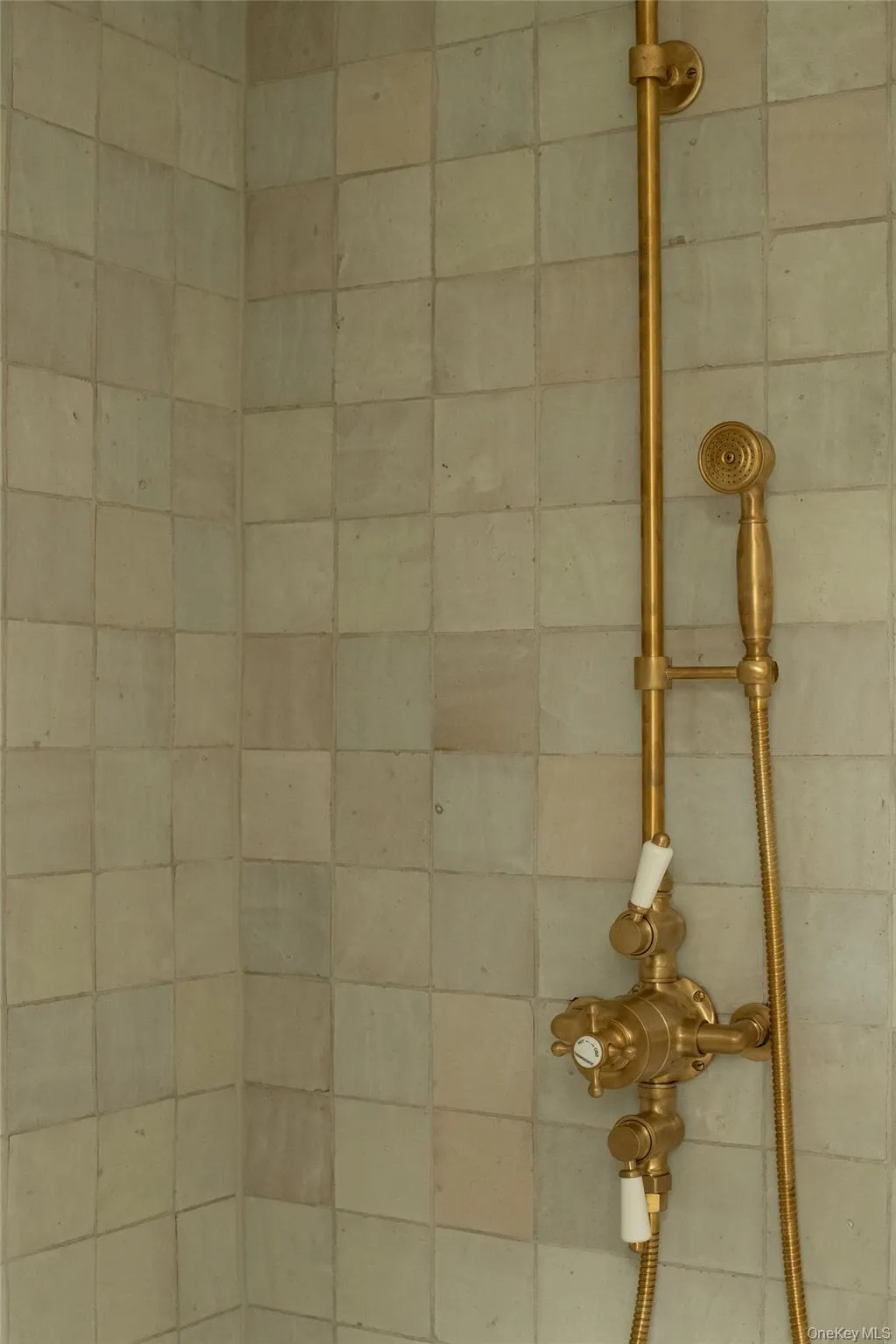 Shower detail with custom tilework and brass fixtures Shower detail with custom tilework and brass fixtures