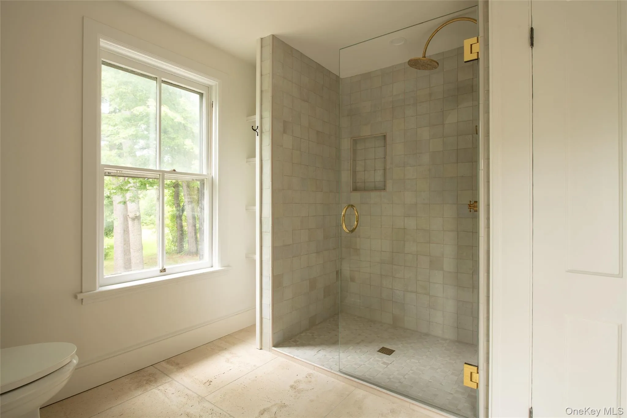Upstairs bathroom with walk-in shower and exquisite ceramic tile and brass fixtures Upstairs bathroom with walk-in shower and exquisite ceramic tile and brass fixtures