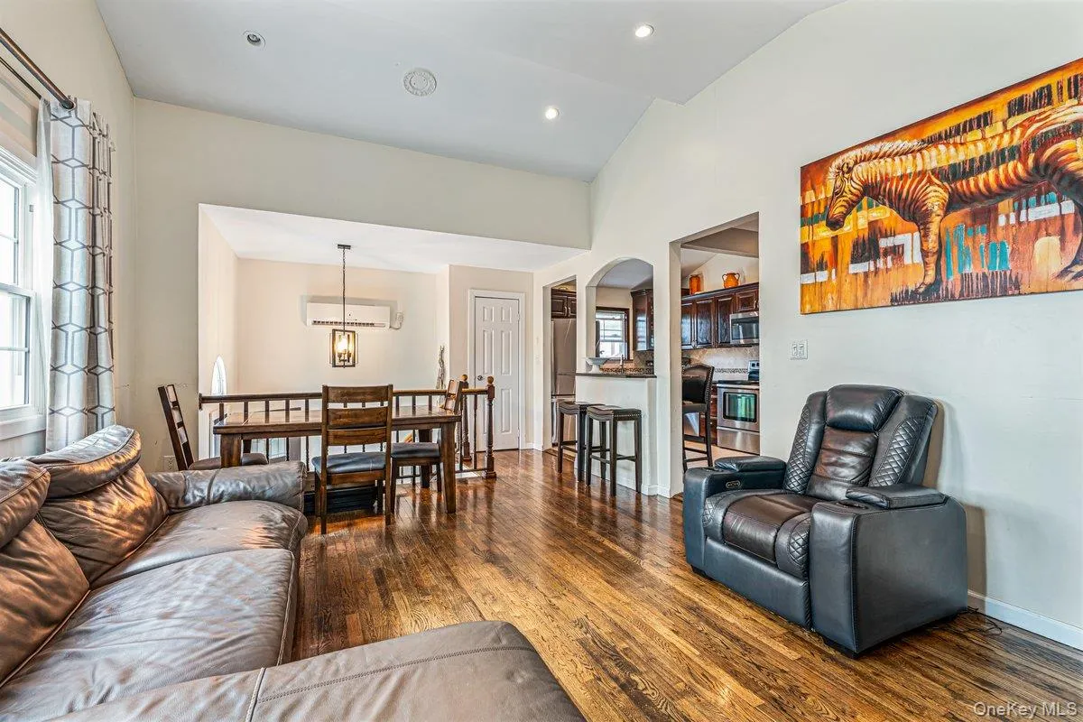 Vaulted ceilings, recessed lighting, wood-finish flooring, and a kitchen pass-through with a breakfast bar Vaulted ceilings, recessed lighting, wood-finish flooring, and a kitchen pass-through with a breakfast bar
