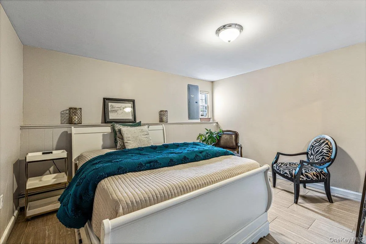 Wood-finish flooring with a neutral wall color and white wainscoting Wood-finish flooring with a neutral wall color and white wainscoting