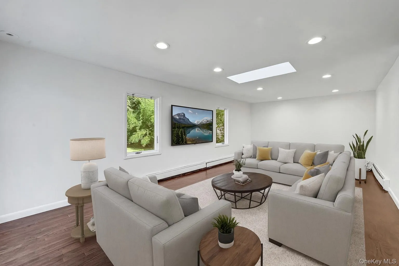 Spacious family room with skylight to maximize natural light - Virtually staged Spacious family room with skylight to maximize natural light - Virtually staged