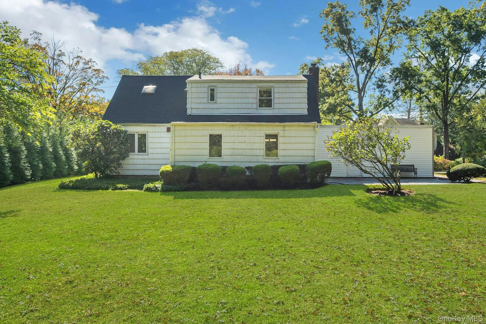 Well-manicured backyard and rear view of home Well-manicured backyard and rear view of home
