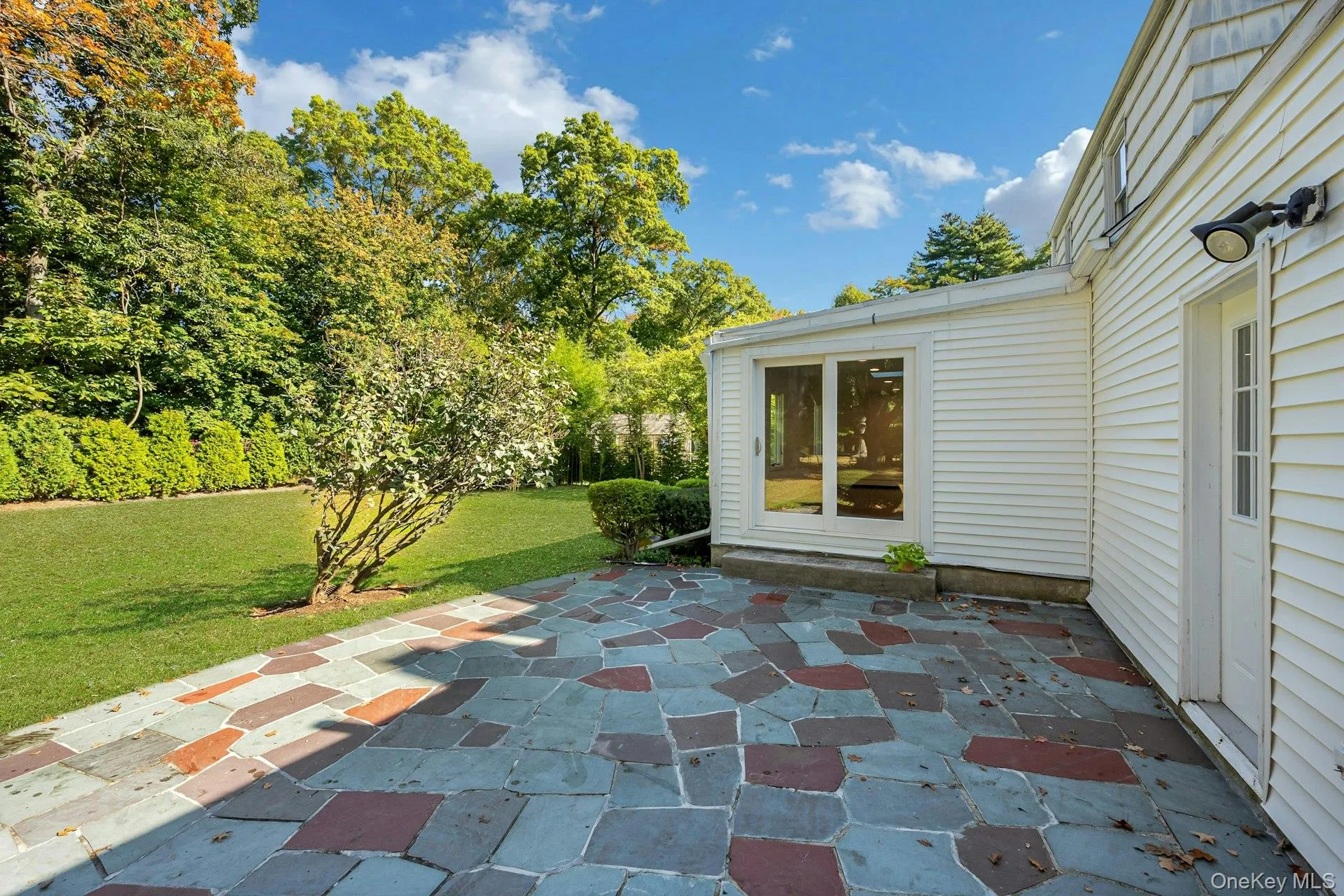 Sizeable backyard patio for barbecuing and entertaining Sizeable backyard patio for barbecuing and entertaining