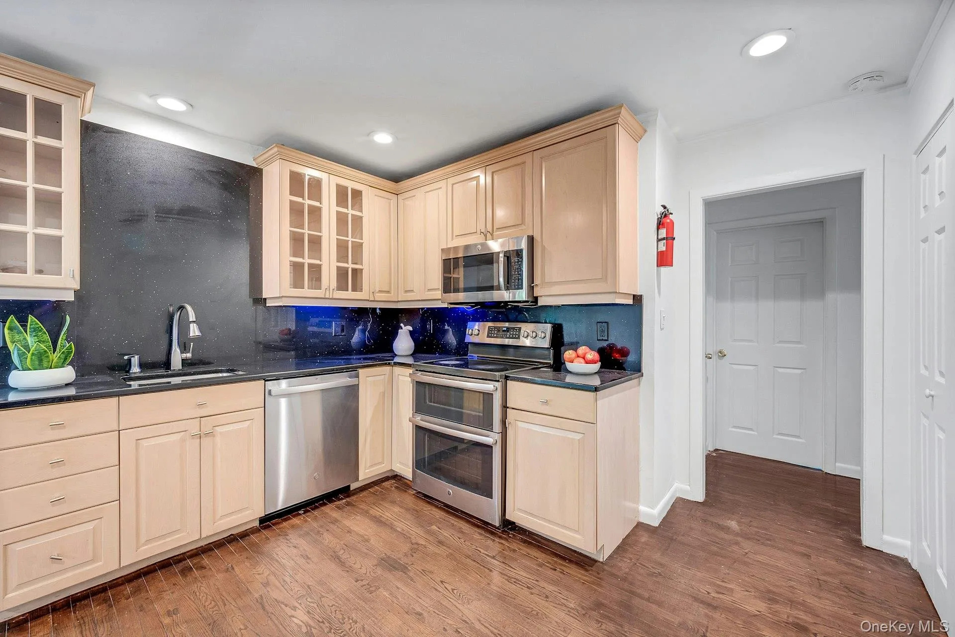 Kitchen with quartz countertops and stainless steel appliances Kitchen with quartz countertops and stainless steel appliances