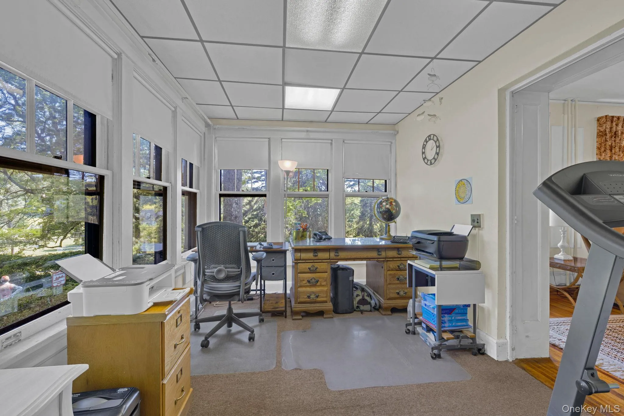 Home office featuring a drop ceiling and light colored carpet Home office featuring a drop ceiling and light colored carpet