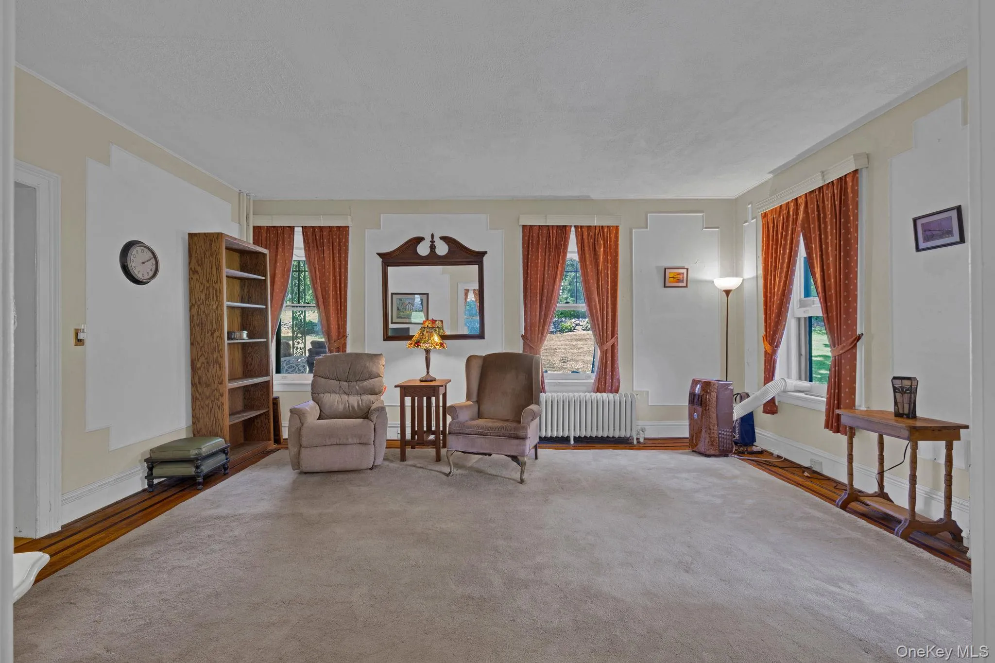 Sitting room with radiator and wood finished floors Sitting room with radiator and wood finished floors