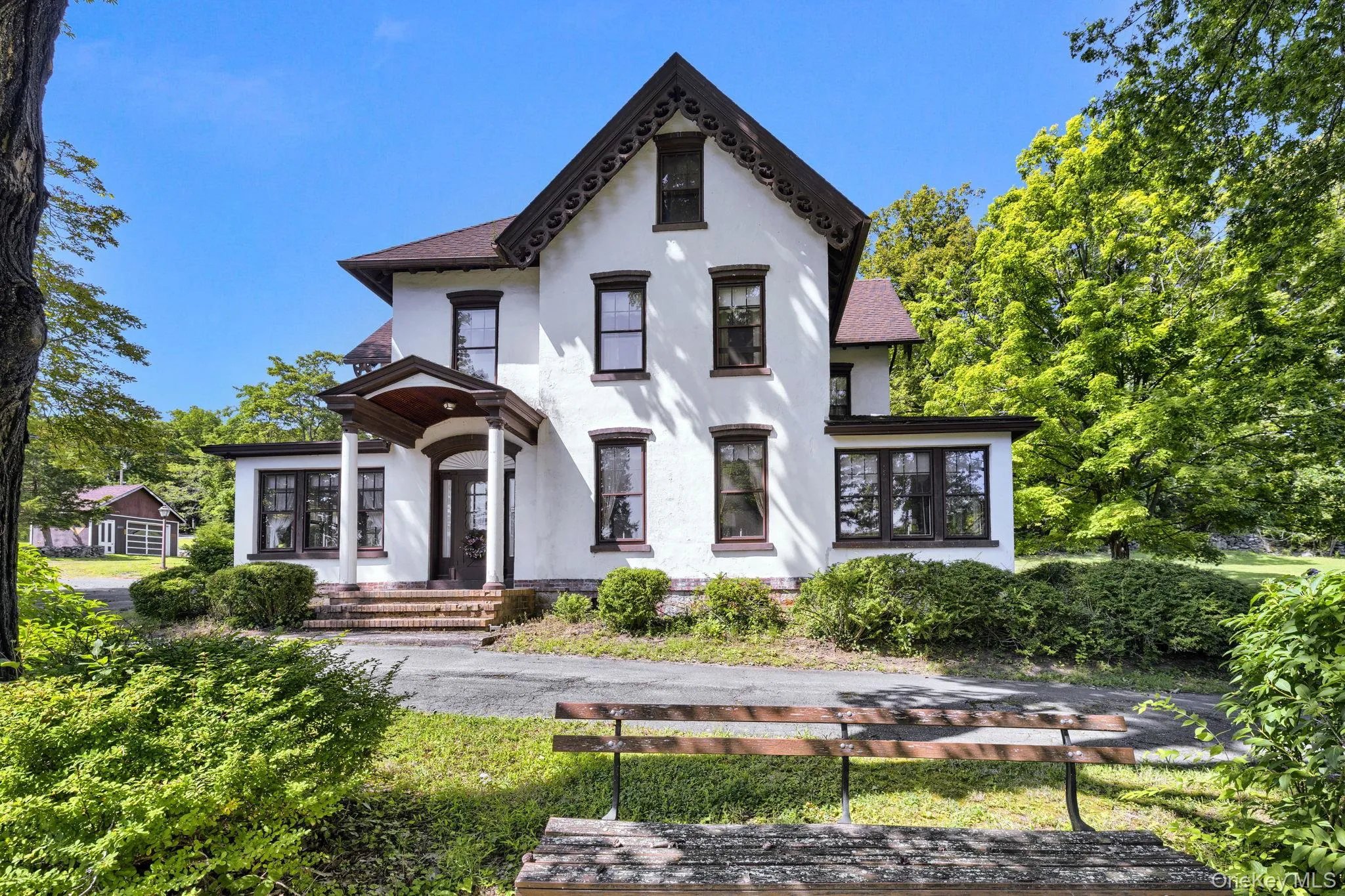 View of front of property featuring stucco siding and a shingled roof View of front of property featuring stucco siding and a shingled roof