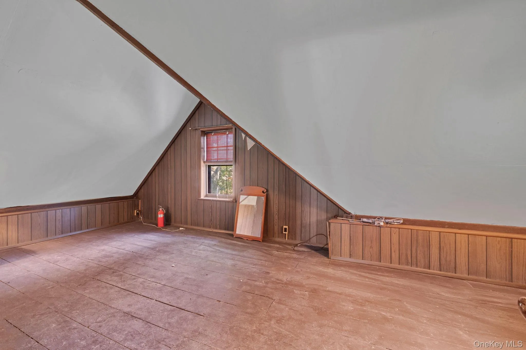 Additional living space featuring wooden walls and vaulted ceiling Additional living space featuring wooden walls and vaulted ceiling