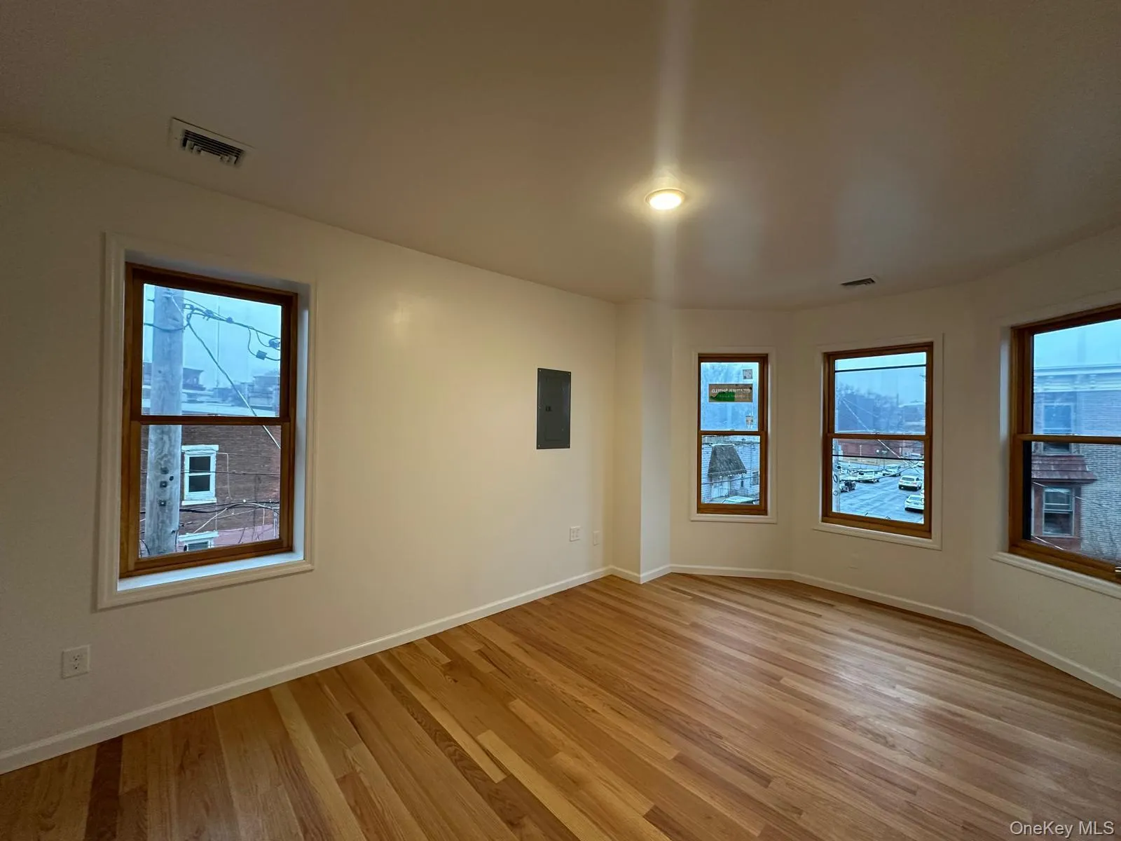 Hardwood flooring, recessed lighting, multiple windows, and a neutral wall palette Hardwood flooring, recessed lighting, multiple windows, and a neutral wall palette