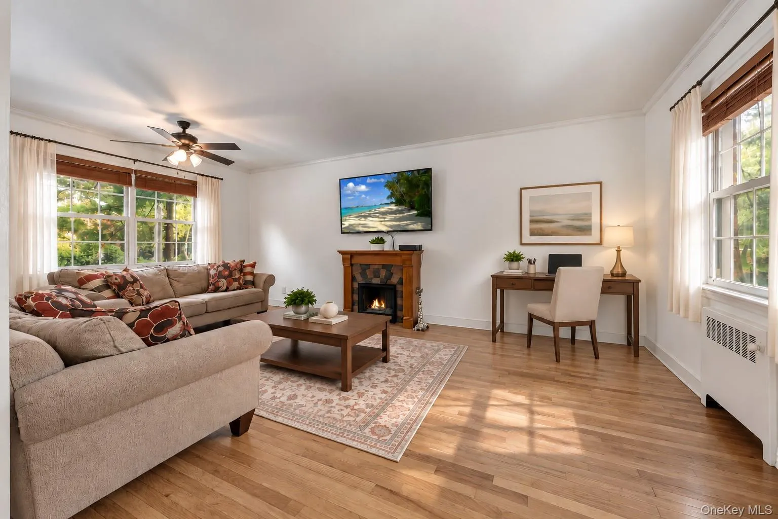 Living Room Featuring Stand-Alone Fireplace and Virtually Staged Home Office Area Living Room Featuring Stand-Alone Fireplace and Virtually Staged Home Office Area