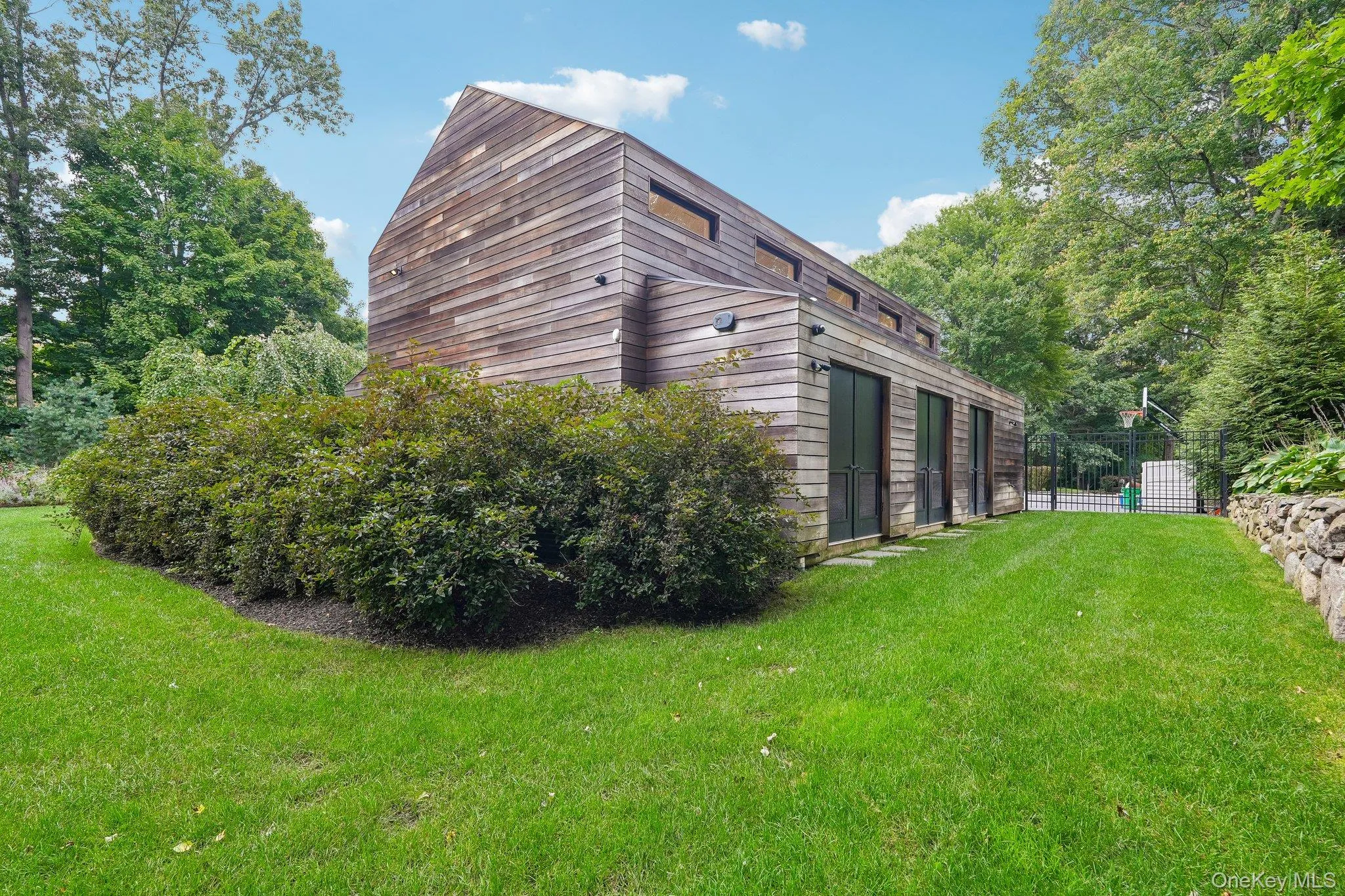 Rear of accessory building with 3 storage units. Rear of accessory building with 3 storage units.