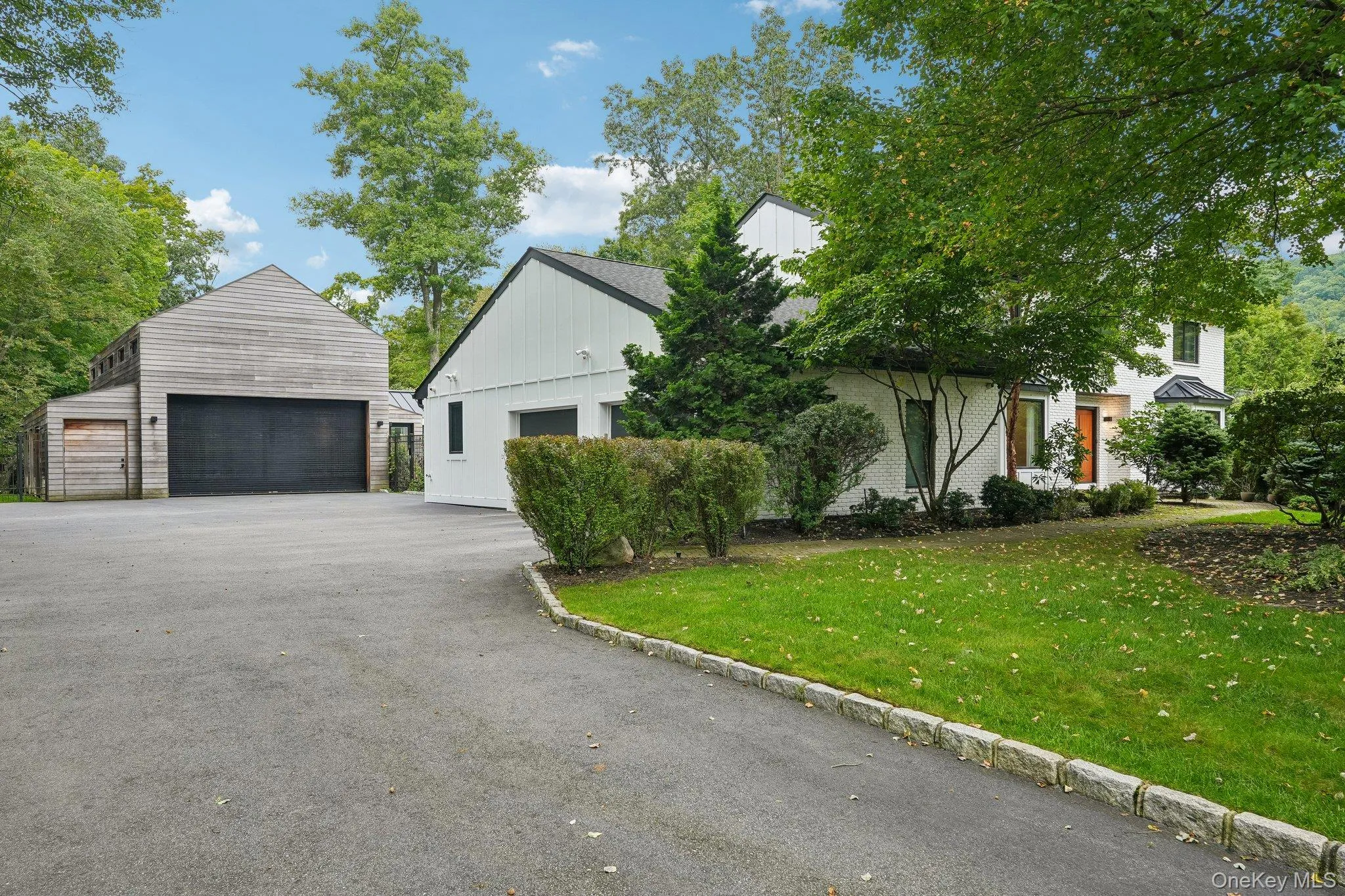 Wide driveway leads to garage and accessory building. Wide driveway leads to garage and accessory building.