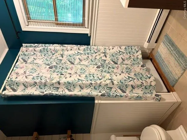 1st floor half bath Board and batten wainscoting, window with blinds, and tiled flooring, Stackable Washer/dryer behind curtain 1st floor half bath Board and batten wainscoting, window with blinds, and tiled flooring, Stackable Washer/dryer behind curtain