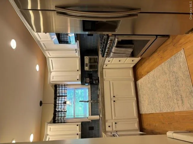 Kitchen has a window over the sink, stainless steel appliances, concrete countertops with beautiful backsplash and recessed lighting Kitchen has a window over the sink, stainless steel appliances, concrete countertops with beautiful backsplash and recessed lighting