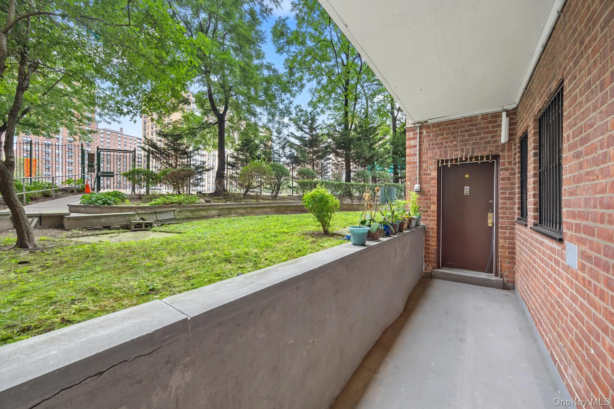 Brick exterior featuring security bars on windows and a covered entryway Brick exterior featuring security bars on windows and a covered entryway