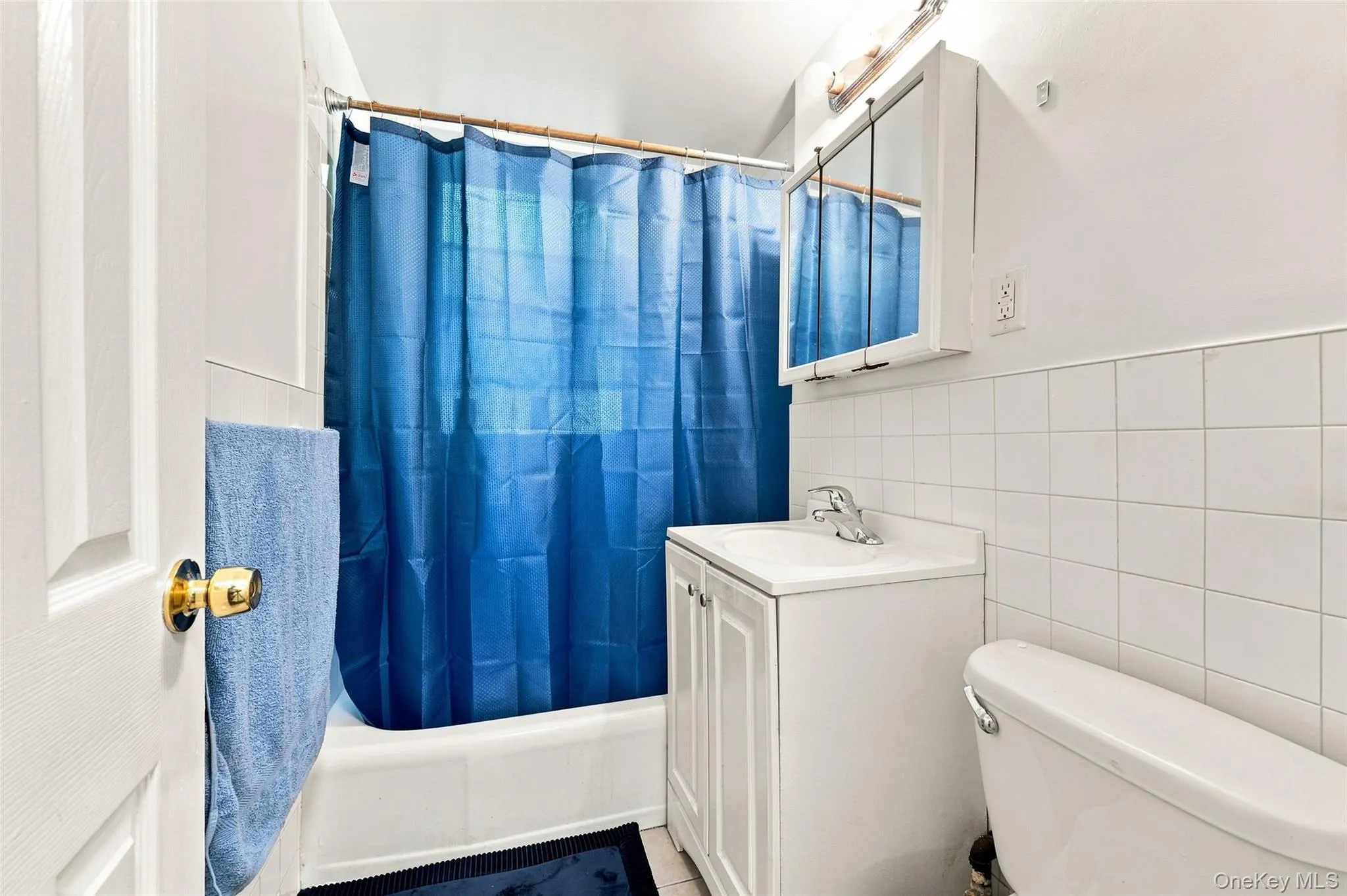 White tile wainscoting with matching shower/tub combination White tile wainscoting with matching shower/tub combination