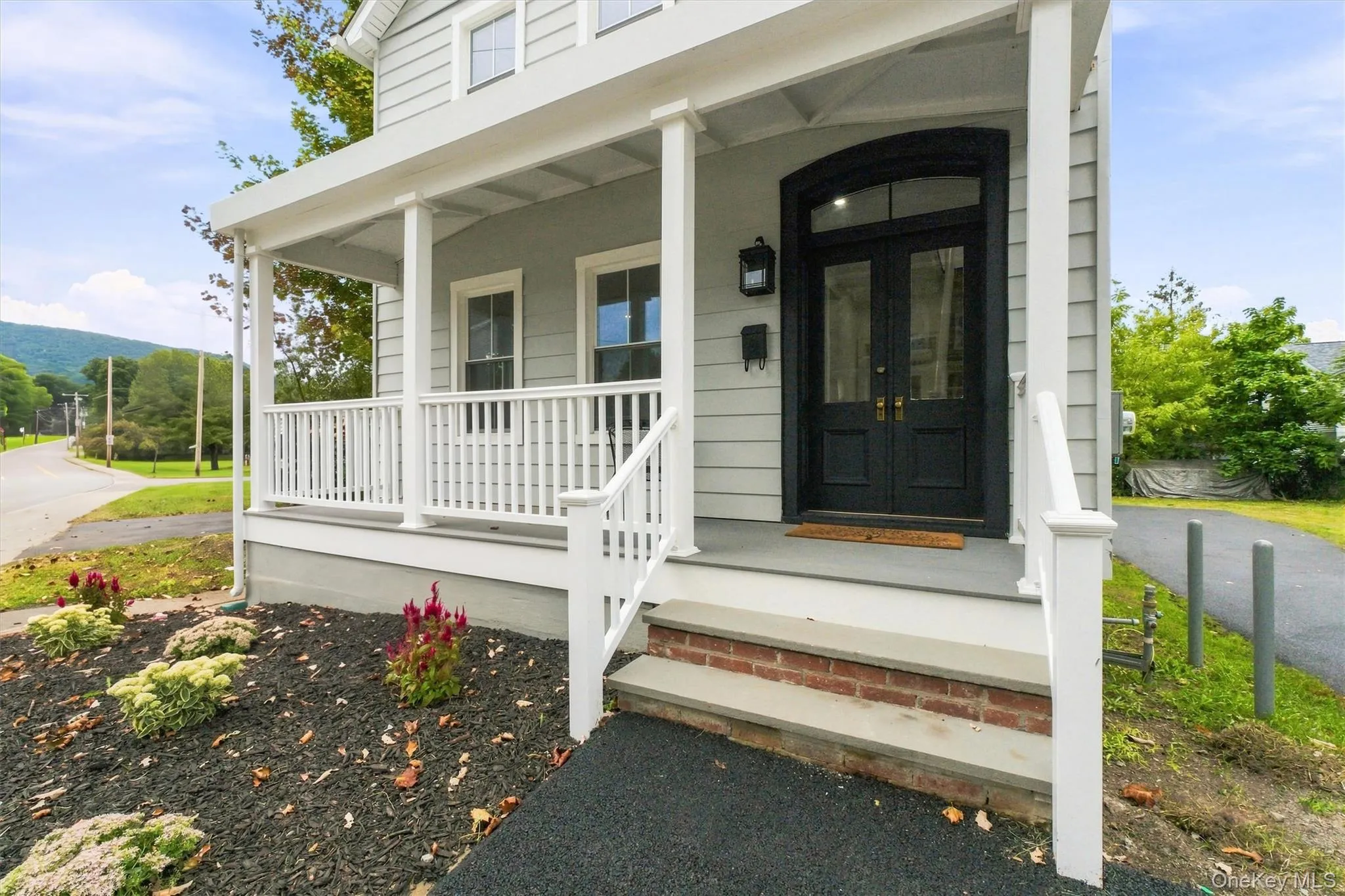 Covered front porch, TREX, with white railings and columns Covered front porch, TREX, with white railings and columns