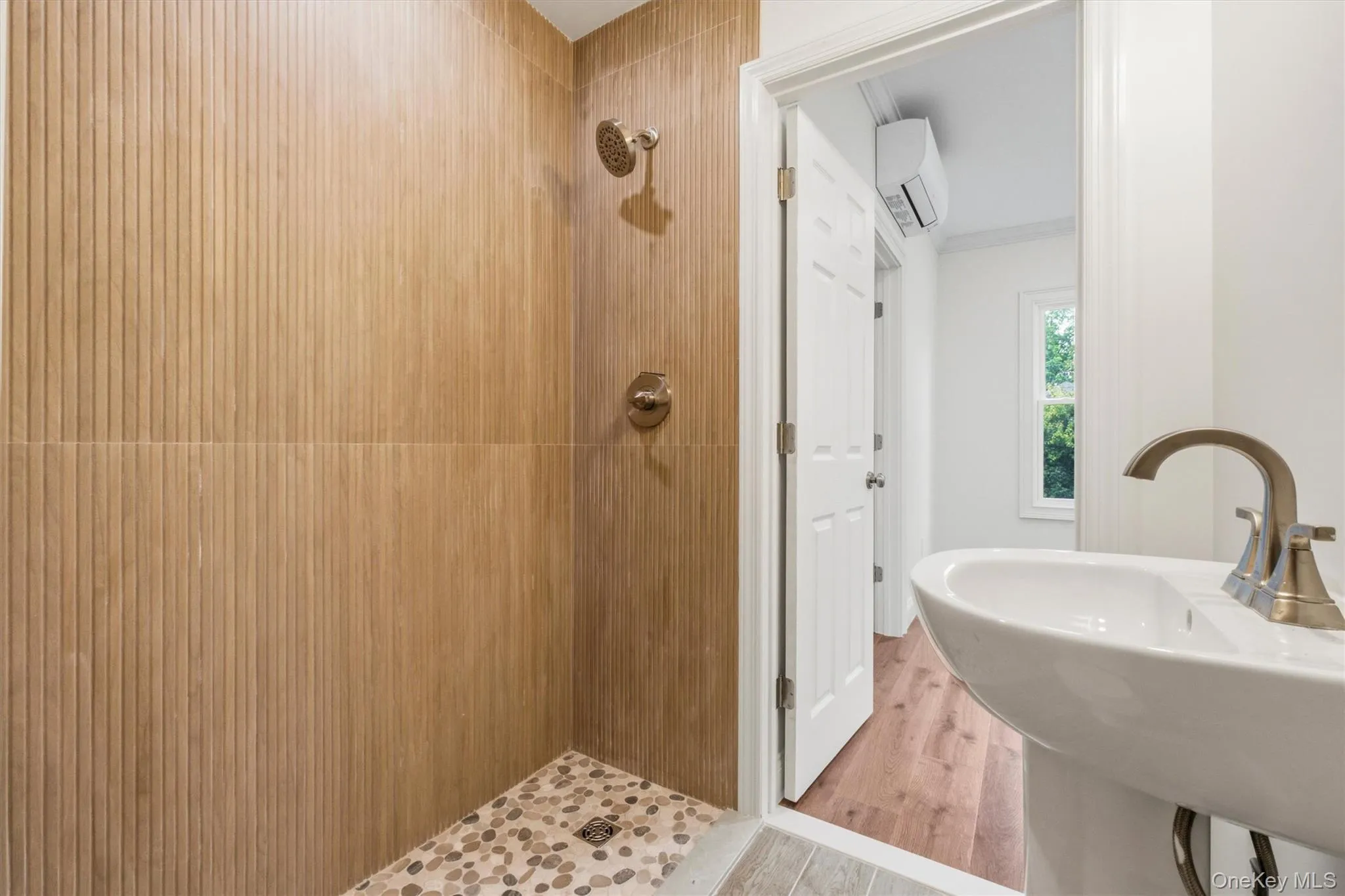 Walk-in shower with vertical plank wall tile and pebble floor Walk-in shower with vertical plank wall tile and pebble floor