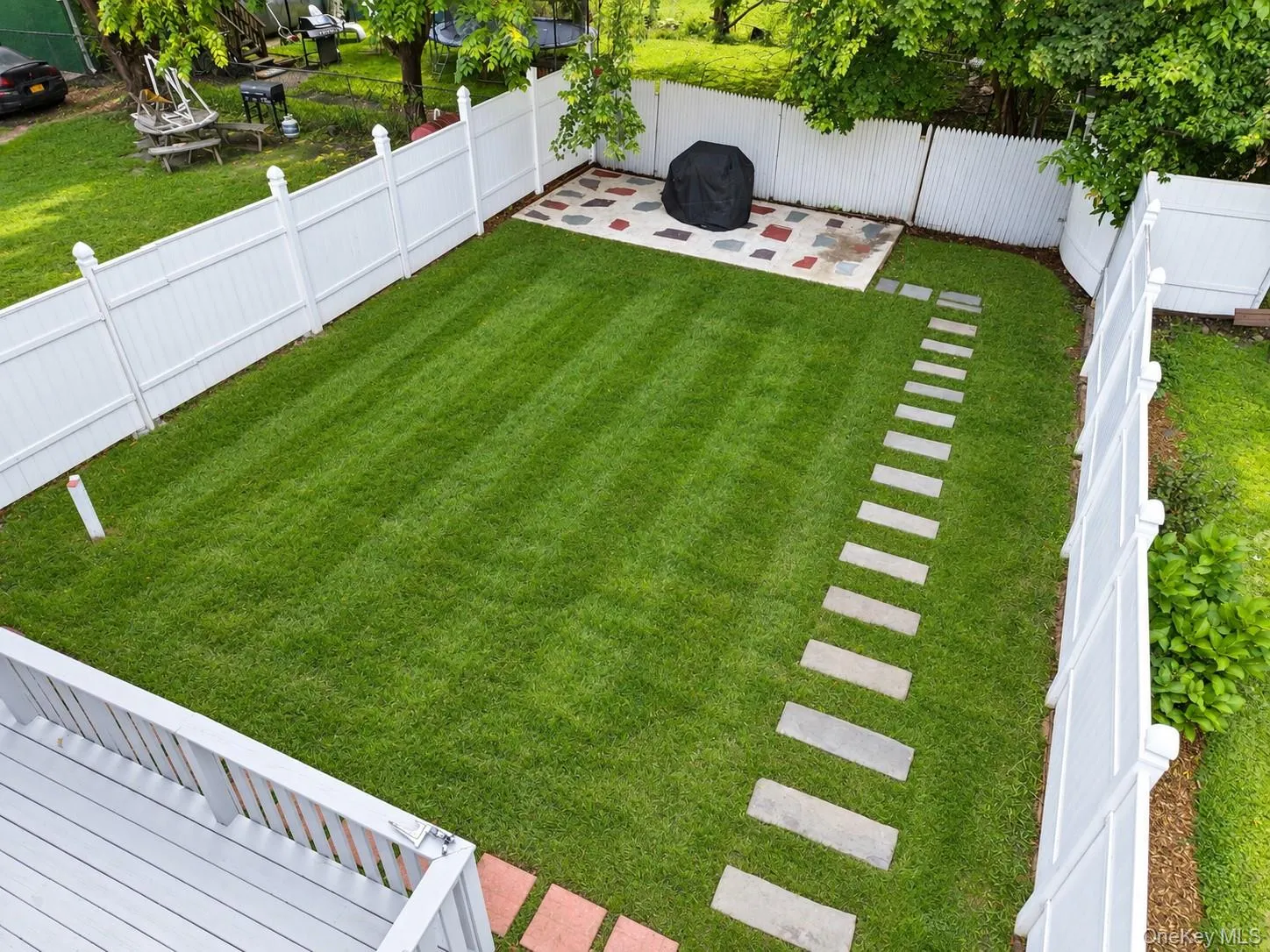 private backyard with the grill area, fully fenced with a large deck private backyard with the grill area, fully fenced with a large deck