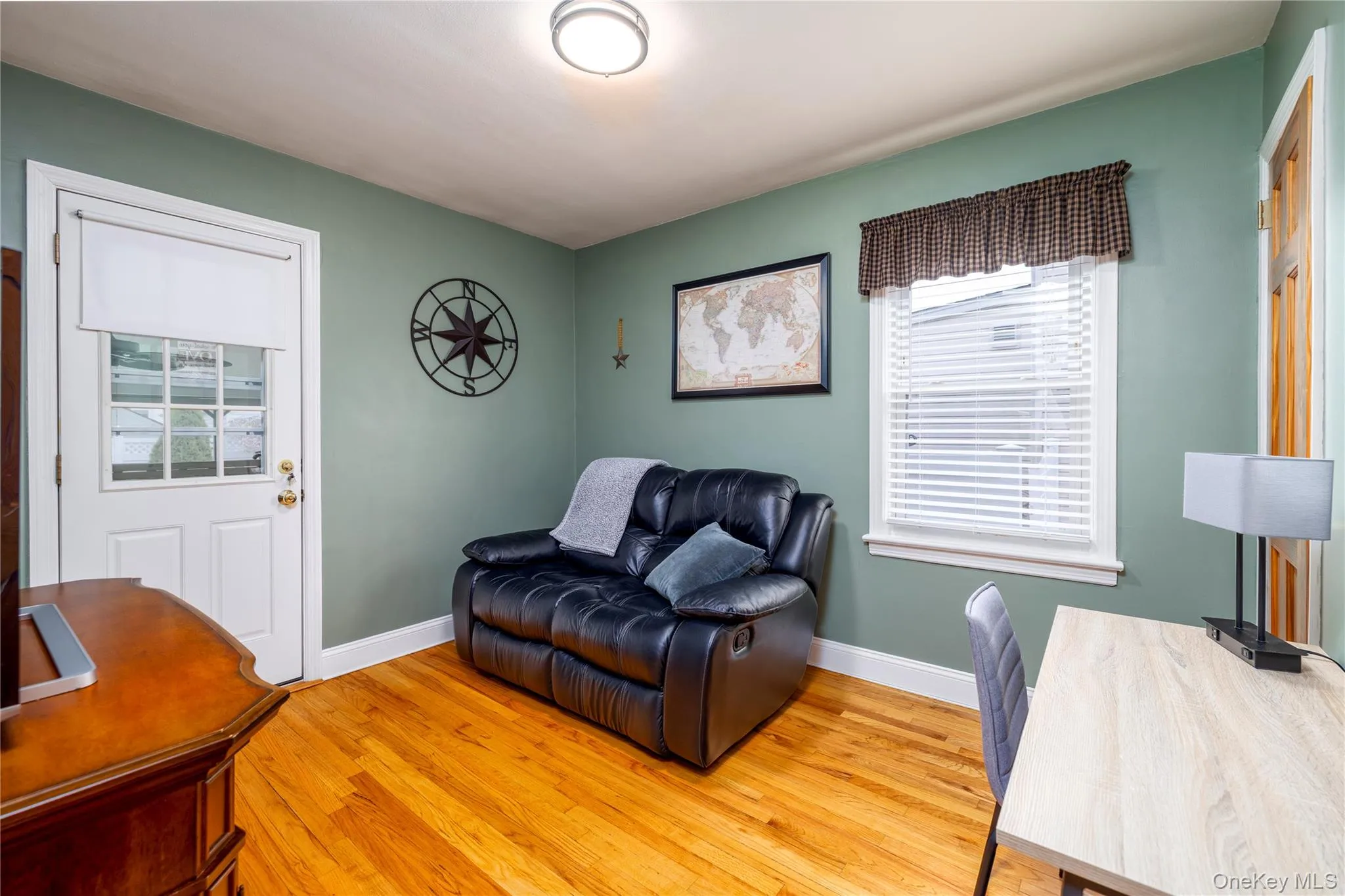 Office space with baseboards and light wood finished floors Office space with baseboards and light wood finished floors