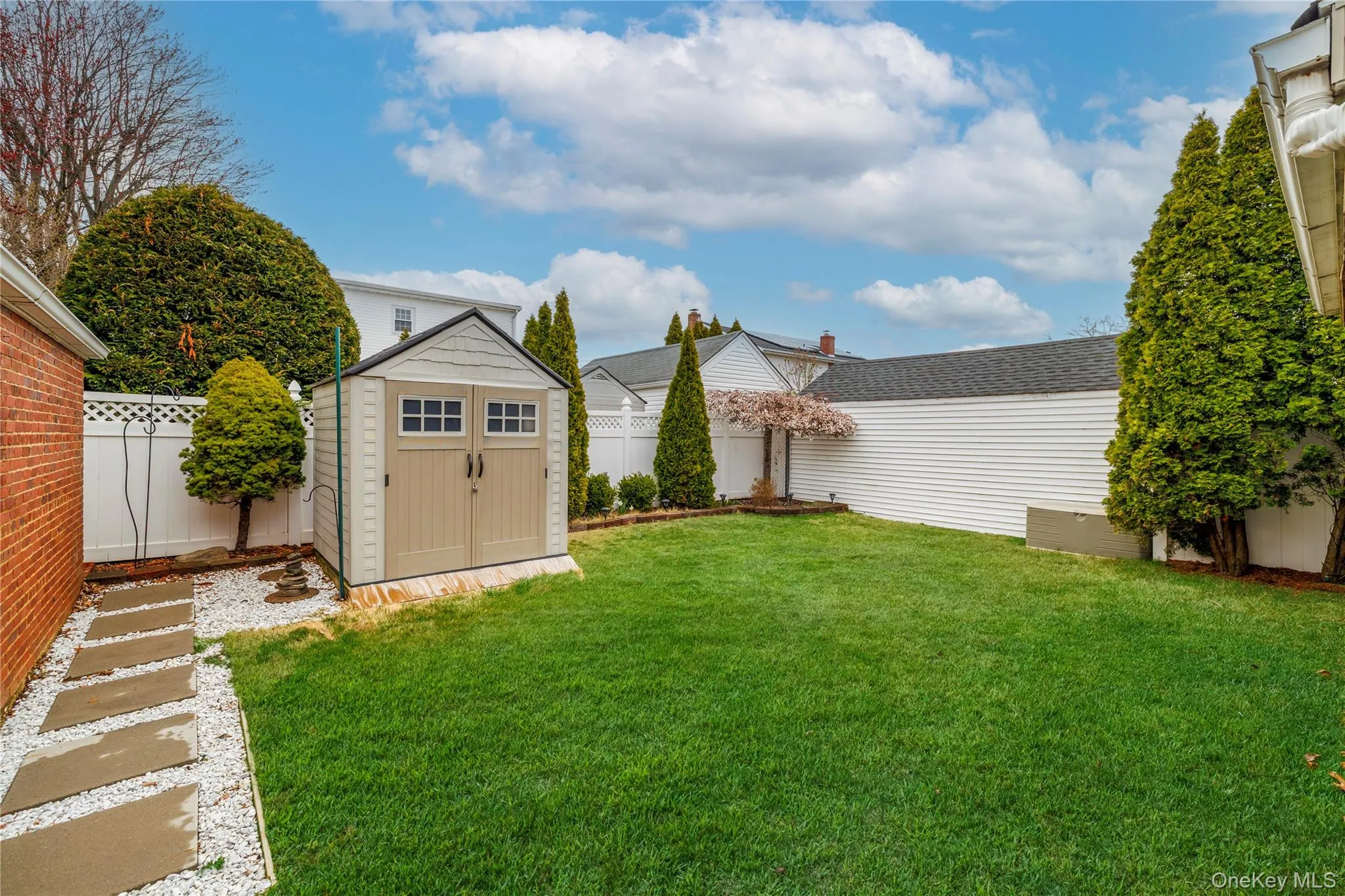 View of yard featuring a storage unit, a fenced backyard, and an outdoor structure View of yard featuring a storage unit, a fenced backyard, and an outdoor structure