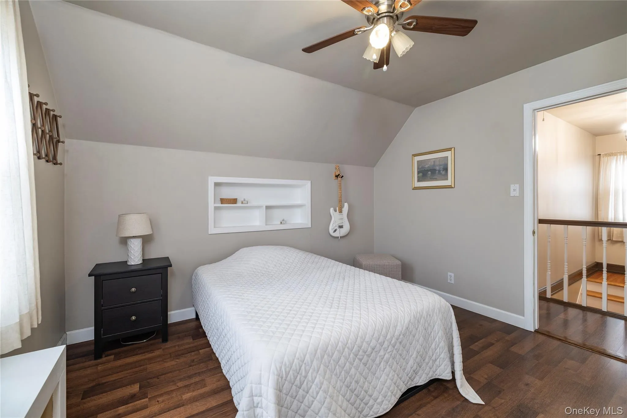 Bedroom with baseboards, ceiling fan, wood finished floors, and vaulted ceiling Bedroom with baseboards, ceiling fan, wood finished floors, and vaulted ceiling