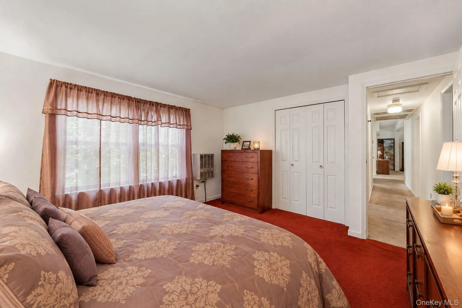 Comfortable bedroom featuring abundant natural light, a roomy layout, and convenient closet space. Comfortable bedroom featuring abundant natural light, a roomy layout, and convenient closet space.