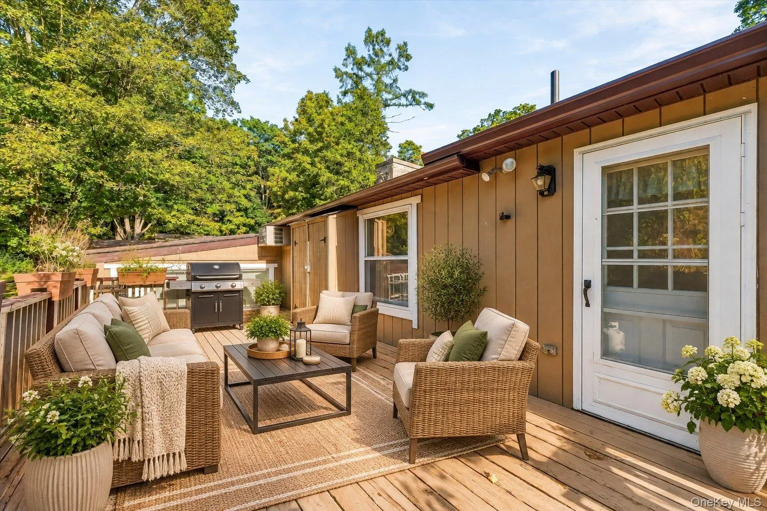 Virtually staged deck showcasing a comfortable outdoor seating area and grilling space. Virtually staged deck showcasing a comfortable outdoor seating area and grilling space.