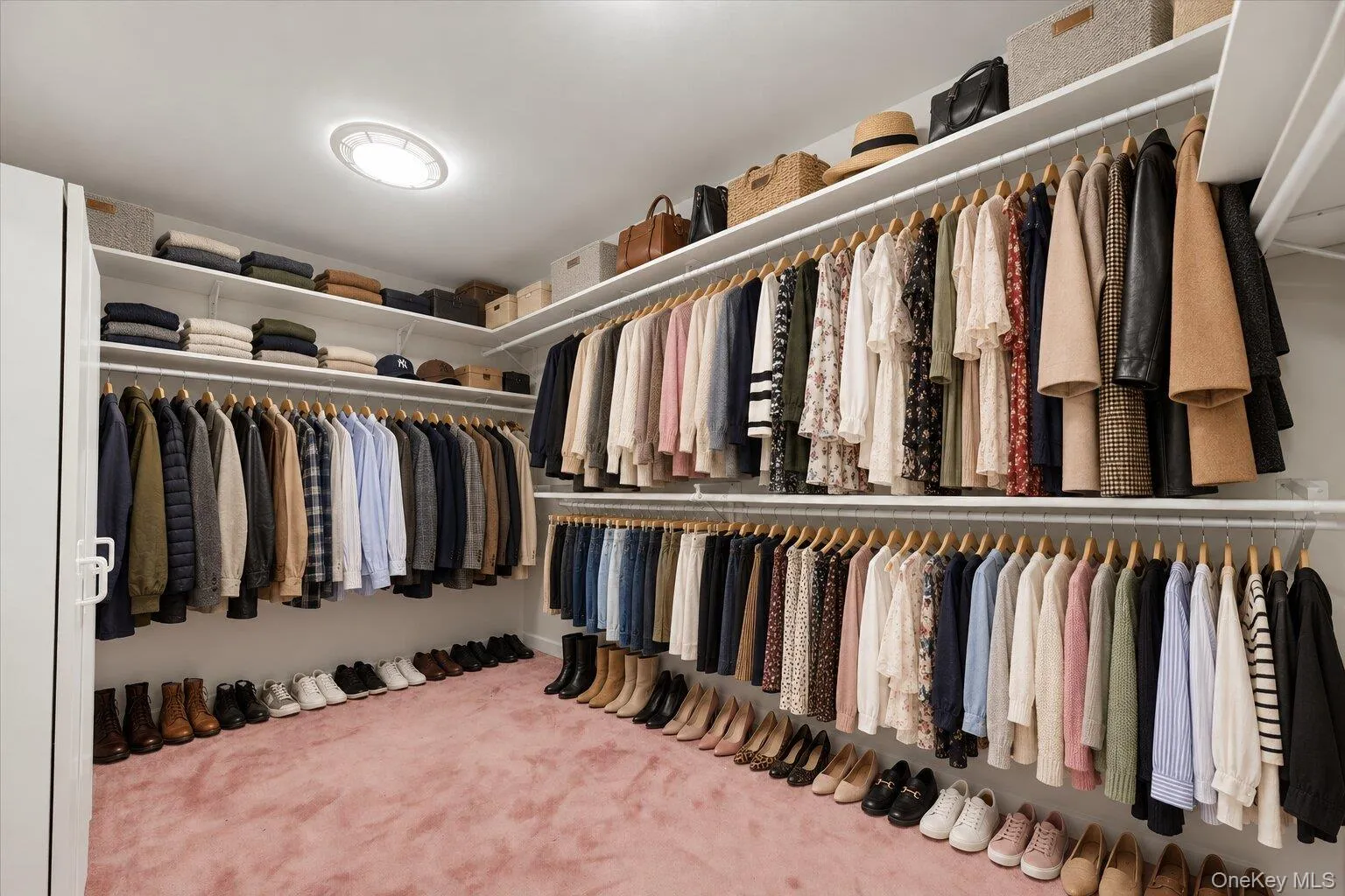 Virtually organized walk-in closet showcasing the generous storage capacity, multiple hanging sections, and abundant shelving. Virtually organized walk-in closet showcasing the generous storage capacity, multiple hanging sections, and abundant shelving.