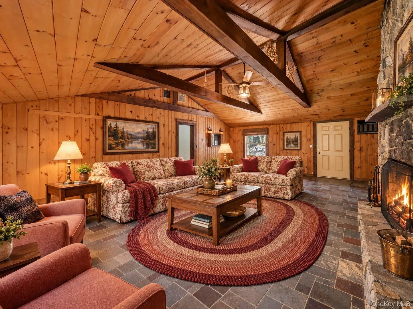 Virtually staged family room showcasing the spacious layout, architectural beams, and impressive stone fireplace. Virtually staged family room showcasing the spacious layout, architectural beams, and impressive stone fireplace.