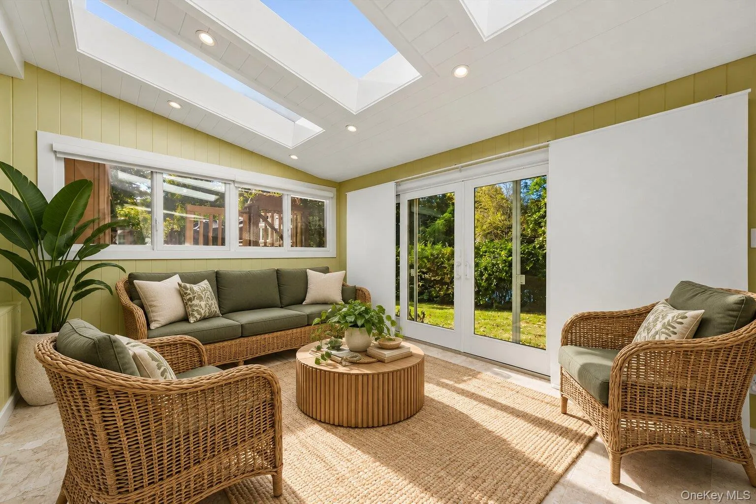 Virtually staged sunroom highlighting the skylights, garden views, and generous space for relaxing or entertaining. Virtually staged sunroom highlighting the skylights, garden views, and generous space for relaxing or entertaining.