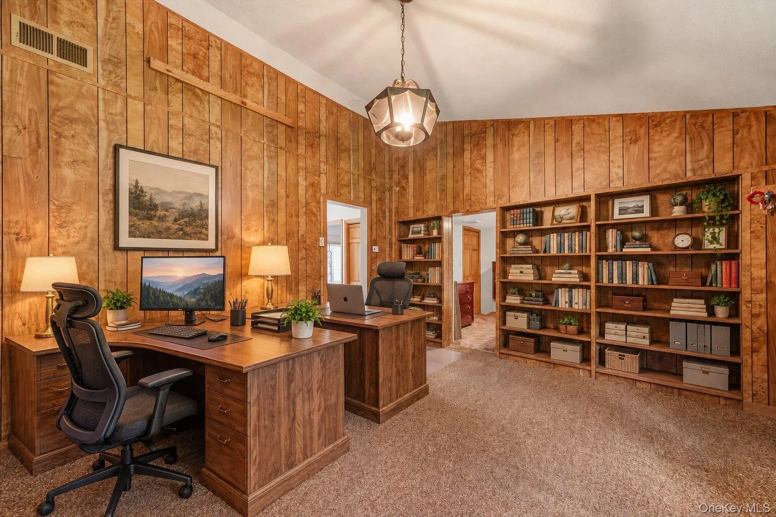 Virtually staged home office showcasing the built-in shelving, generous workspace, and potential for multiple workstations. Virtually staged home office showcasing the built-in shelving, generous workspace, and potential for multiple workstations.