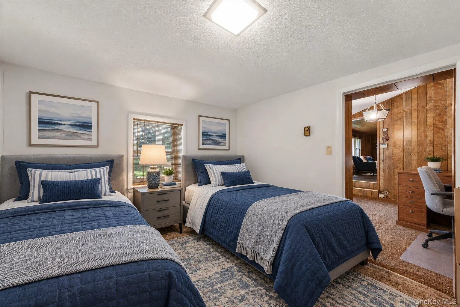 Virtually staged bedroom showcasing a twin-bed layout with space for a dedicated desk or study area. Virtually staged bedroom showcasing a twin-bed layout with space for a dedicated desk or study area.