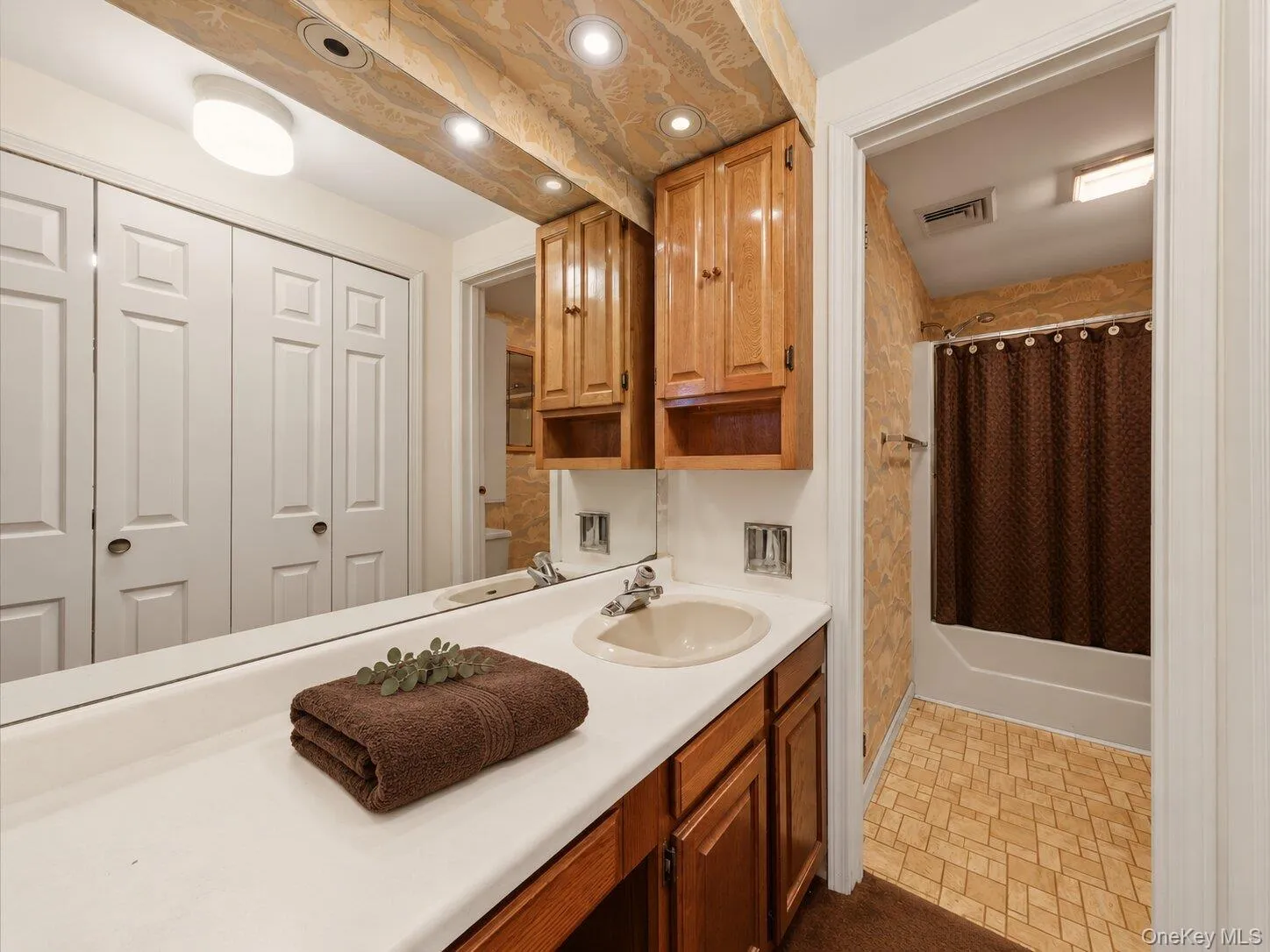 Primary bathroom highlighting the spacious vanity, storage, and tub/shower area. Primary bathroom highlighting the spacious vanity, storage, and tub/shower area.