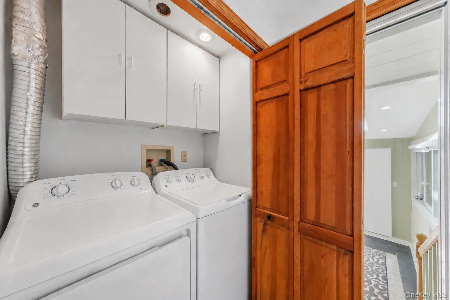 Convenient laundry area with side-by-side washer and dryer, overhead cabinetry, and additional storage. Convenient laundry area with side-by-side washer and dryer, overhead cabinetry, and additional storage.