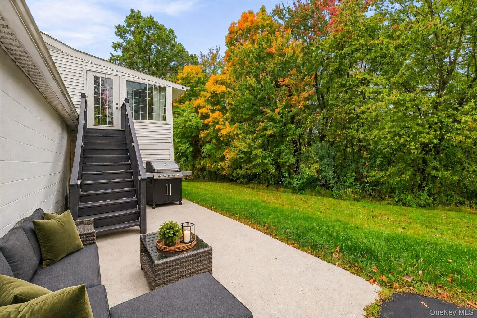 Virtually staged Mattress, throw Pillow, barbeque Grill and decluttered. Additional patio view featuring outdoor seating, barbecue grill, exterior staircase, grassy yard, and mature trees along the property. Virtually staged Mattress, throw Pillow, barbeque Grill and decluttered. Additional patio view featuring outdoor seating, barbecue grill, exterior staircase, grassy yard, and mature trees along the property.