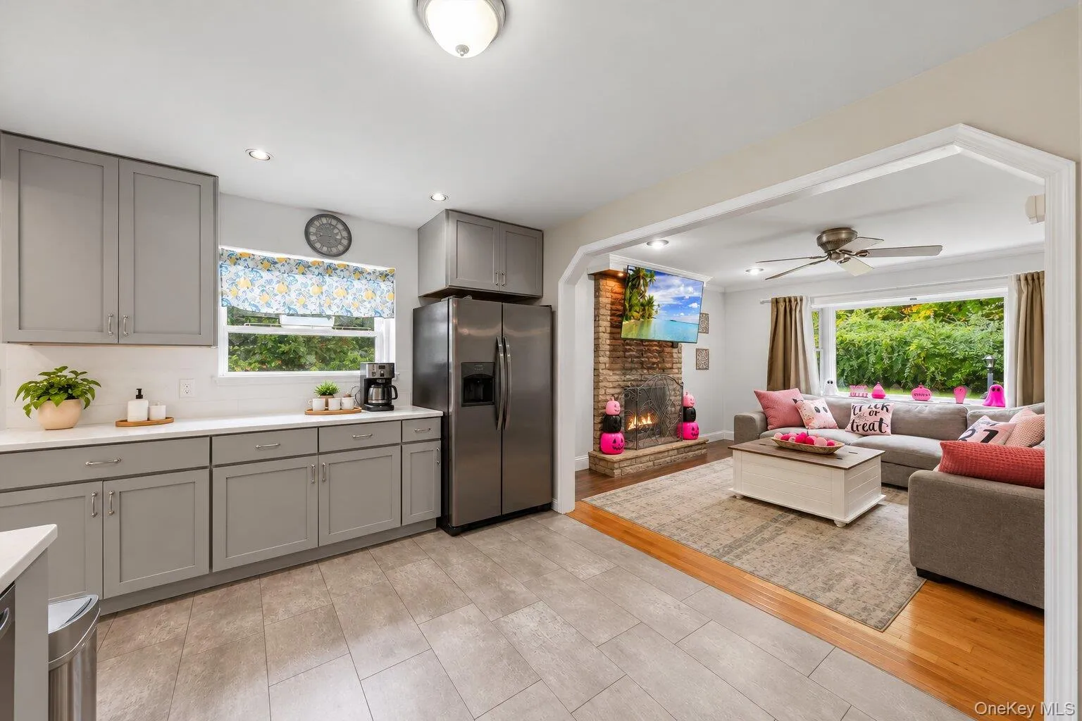 Virtually decluttered. Kitchen with ample cabinetry, stainless steel refrigerator, generous countertop space, and an open view into the living room. Virtually decluttered. Kitchen with ample cabinetry, stainless steel refrigerator, generous countertop space, and an open view into the living room.