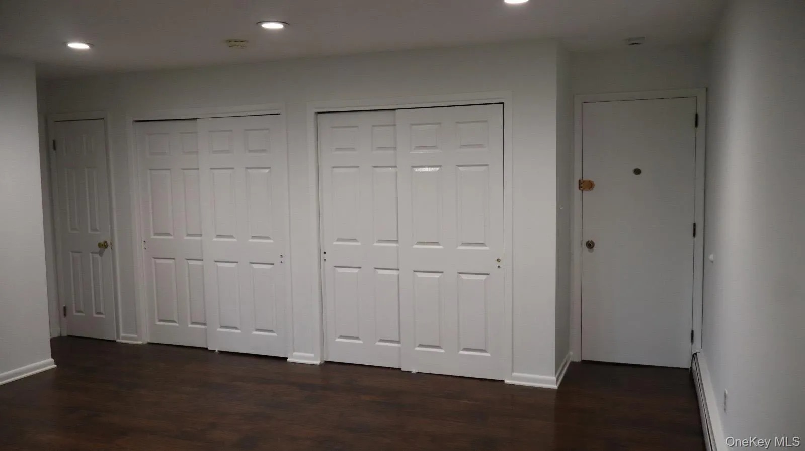 Recessed lighting, wood-finish flooring, and white trim Recessed lighting, wood-finish flooring, and white trim