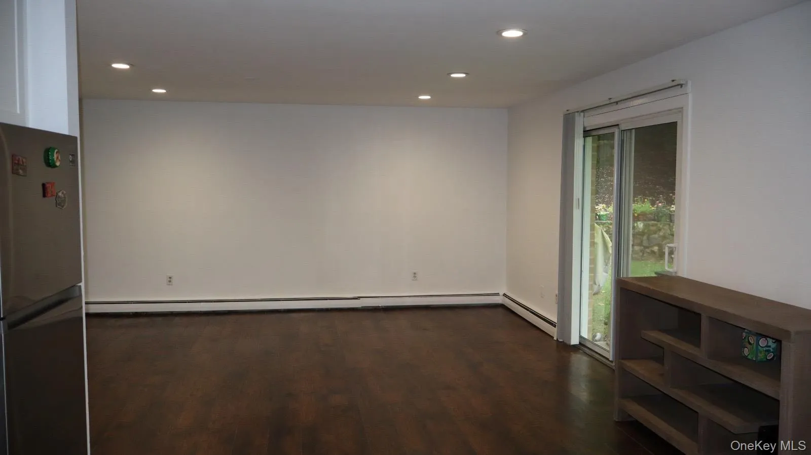 Recessed lighting, wood-finish flooring, sliding glass door, and baseboard heating Recessed lighting, wood-finish flooring, sliding glass door, and baseboard heating