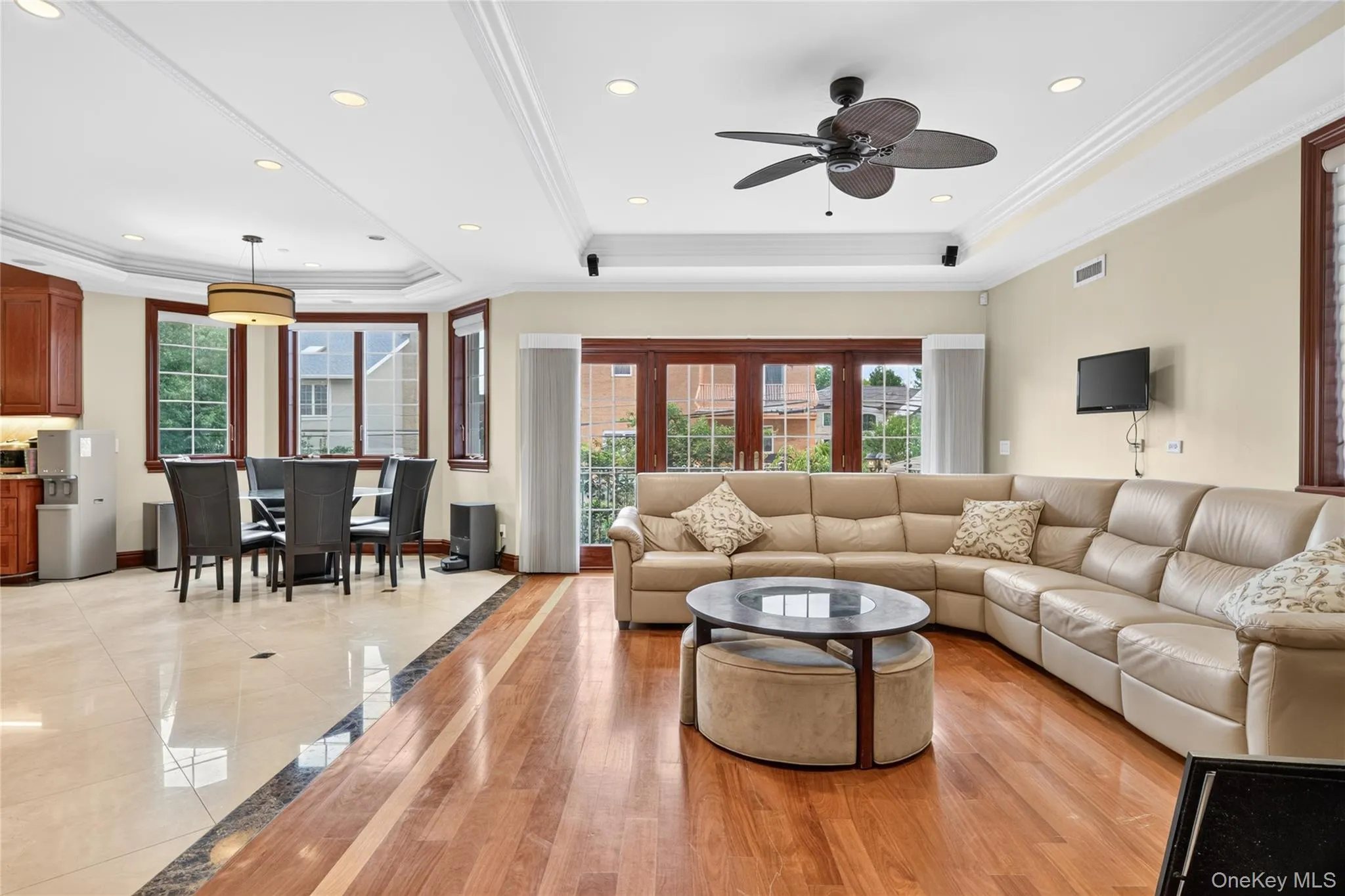 Recessed lighting, crown molding, wood-finish flooring, tiled flooring, and a ceiling fan Recessed lighting, crown molding, wood-finish flooring, tiled flooring, and a ceiling fan