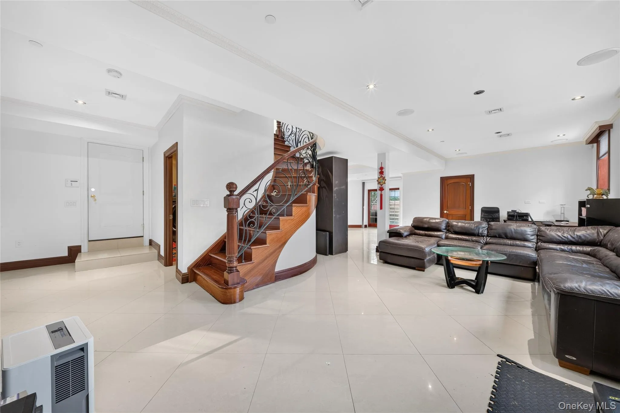 Spacious room featuring light-toned flooring, recessed lighting, and crown molding Spacious room featuring light-toned flooring, recessed lighting, and crown molding