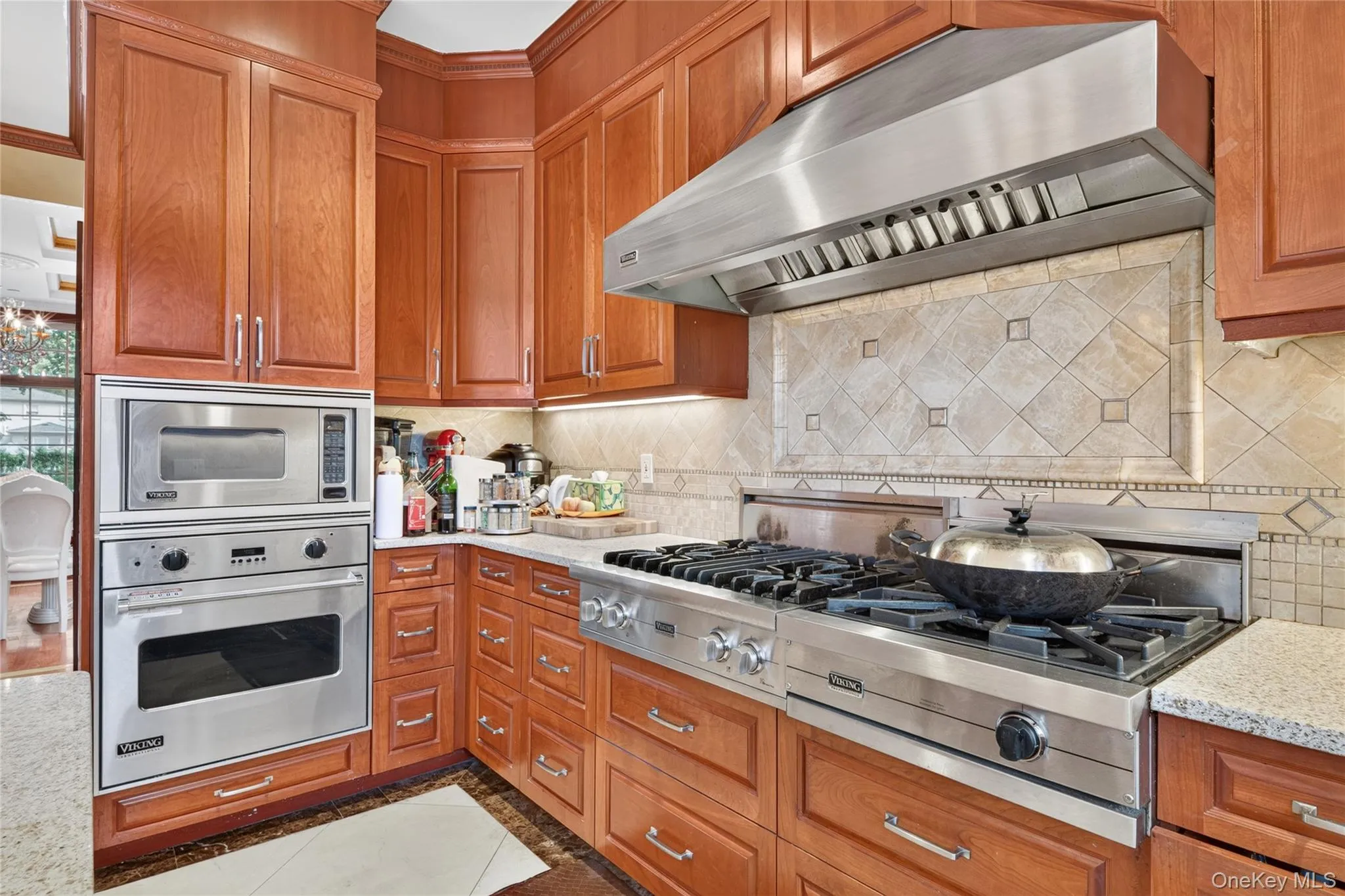Cherry wood cabinetry complemented by granite countertops Cherry wood cabinetry complemented by granite countertops