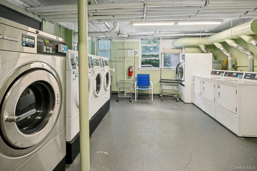 Modern laundry room located close to unit Modern laundry room located close to unit