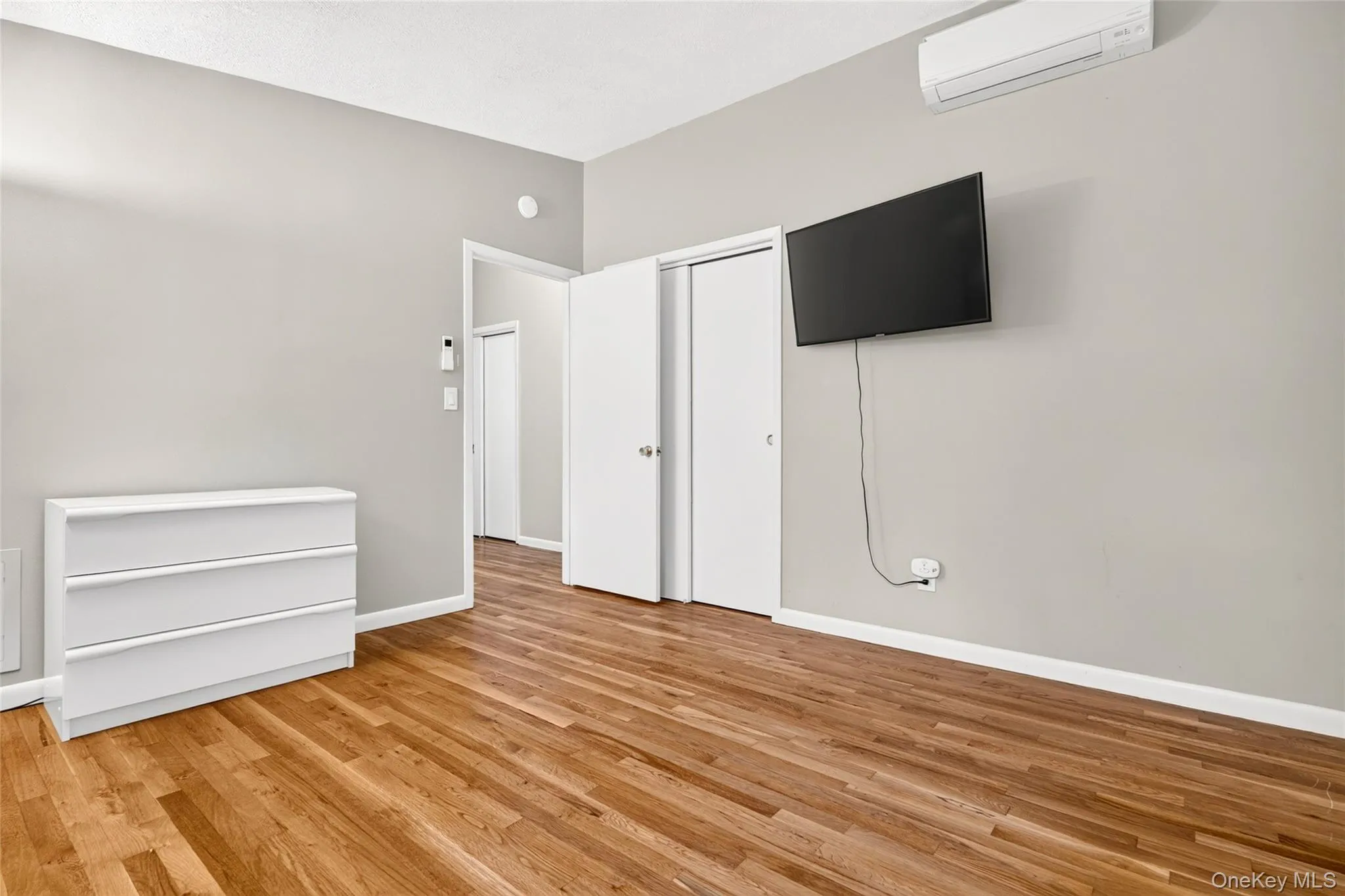 Hardwood-finish flooring, light gray wall paint, and white trim Hardwood-finish flooring, light gray wall paint, and white trim