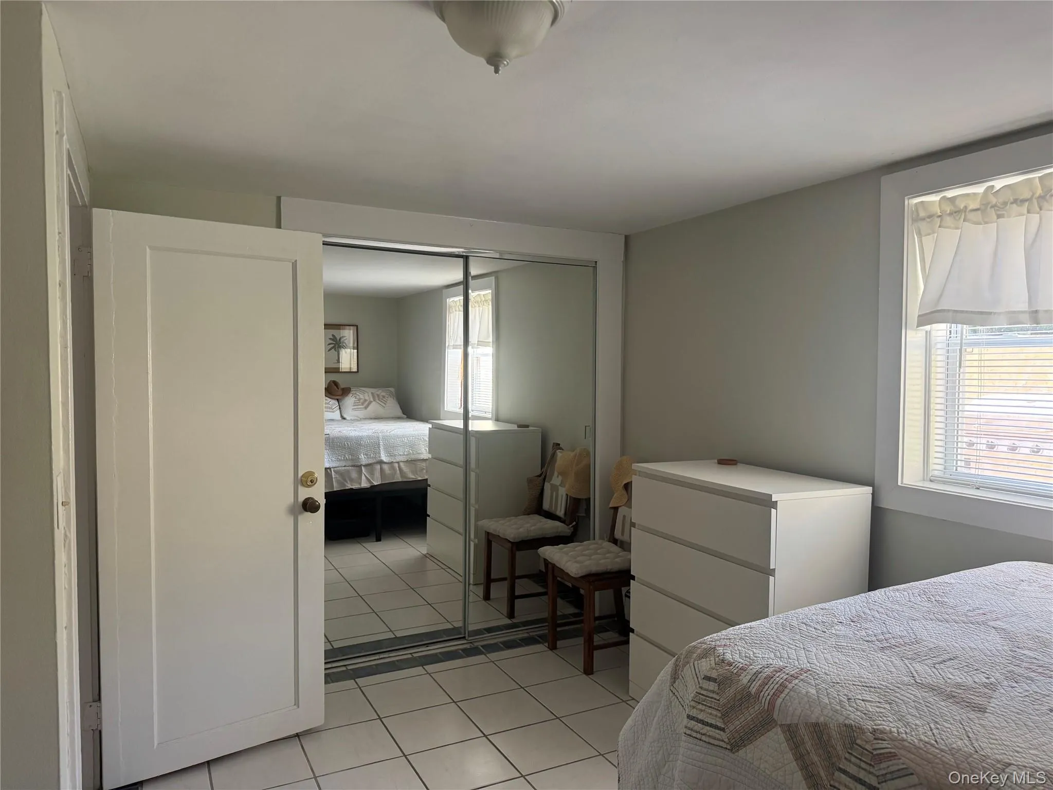 Bedroom with light tile patterned floors and a closet Bedroom with light tile patterned floors and a closet