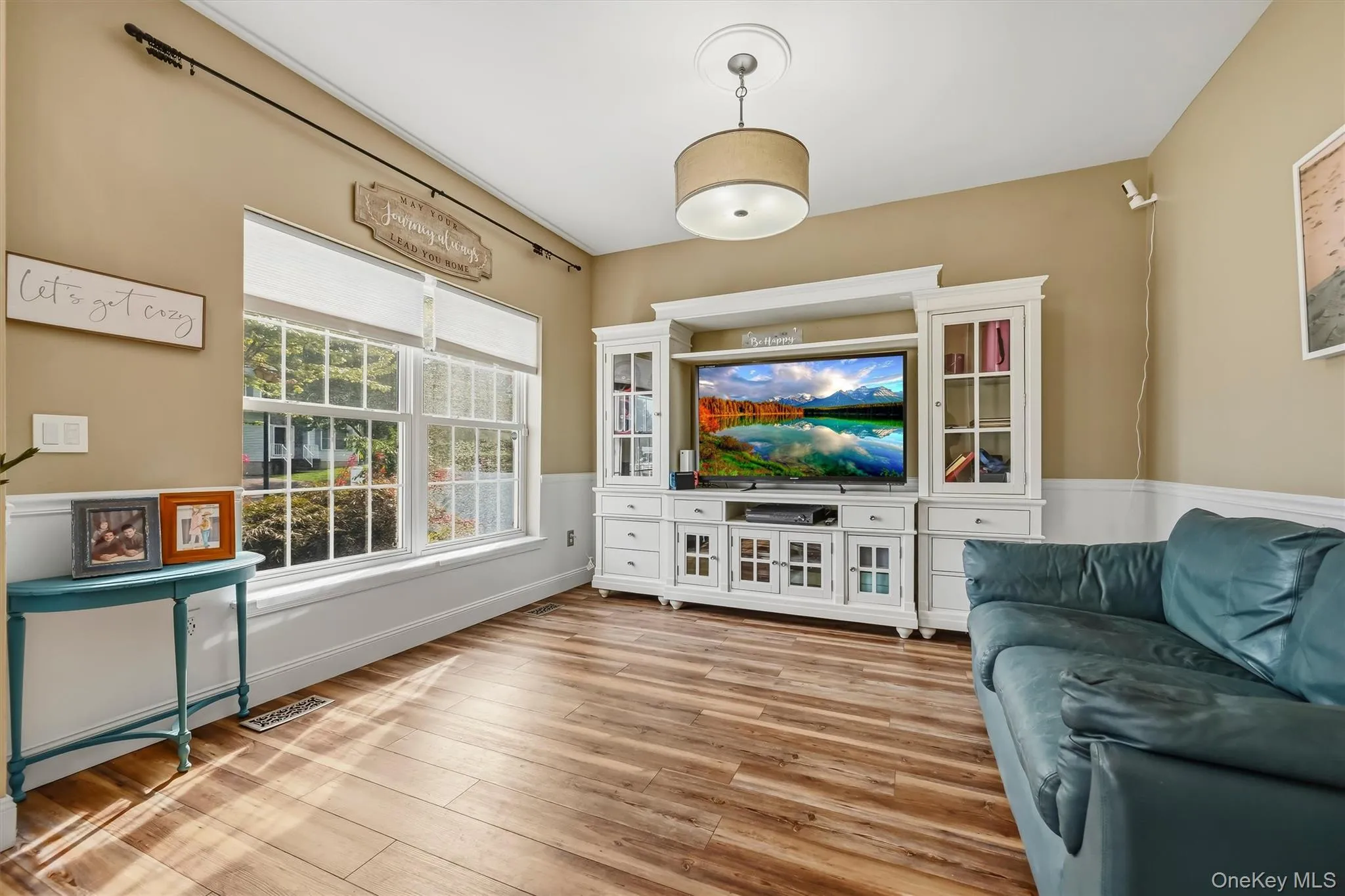 The living room offers custom molding and huge windows. The living room offers custom molding and huge windows.