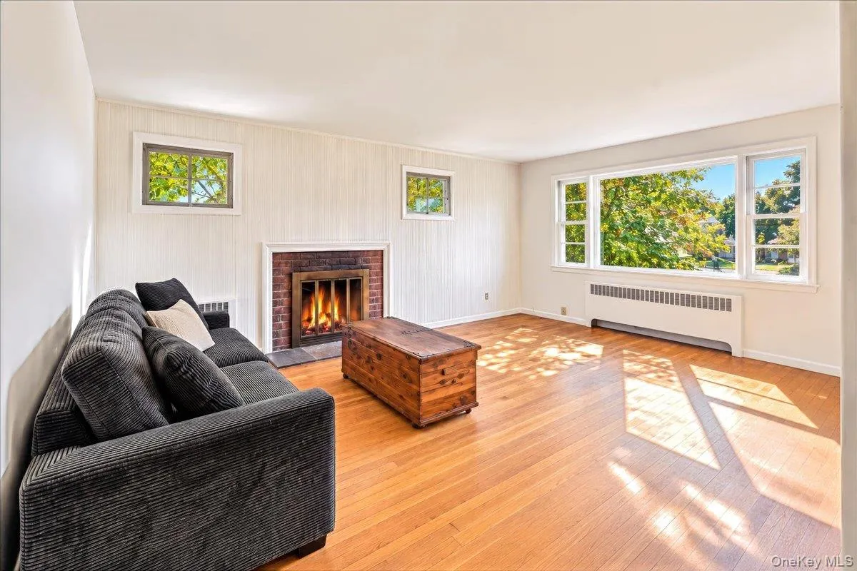 Living Room with Fireplace and Bay window looking West Living Room with Fireplace and Bay window looking West