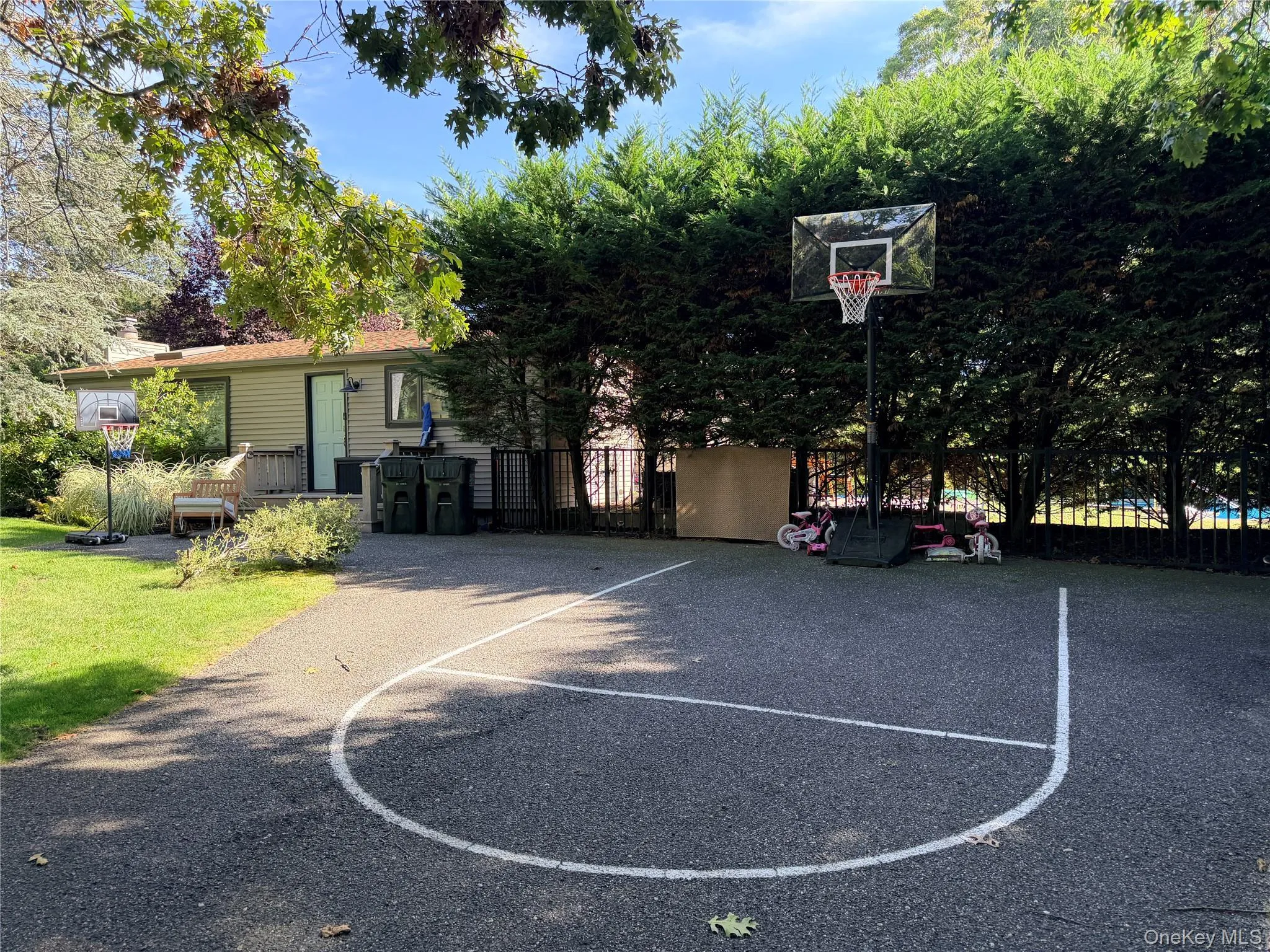 Driveway that doubles as a small basketball court. Fits 3 cars. Driveway that doubles as a small basketball court. Fits 3 cars.