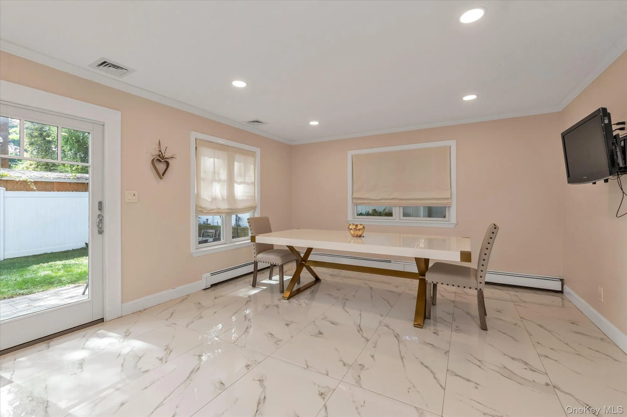 Ideal for entertaining with an open floor plan, crown molding, recessed lighting, and sliding glass doors to patio. Ideal for entertaining with an open floor plan, crown molding, recessed lighting, and sliding glass doors to patio.